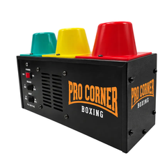 A black metal boxing ring light machine with three colored cones on top: teal, yellow, and red. The front and side panels are printed with 'PRO CORNER BOXING' in orange and white.